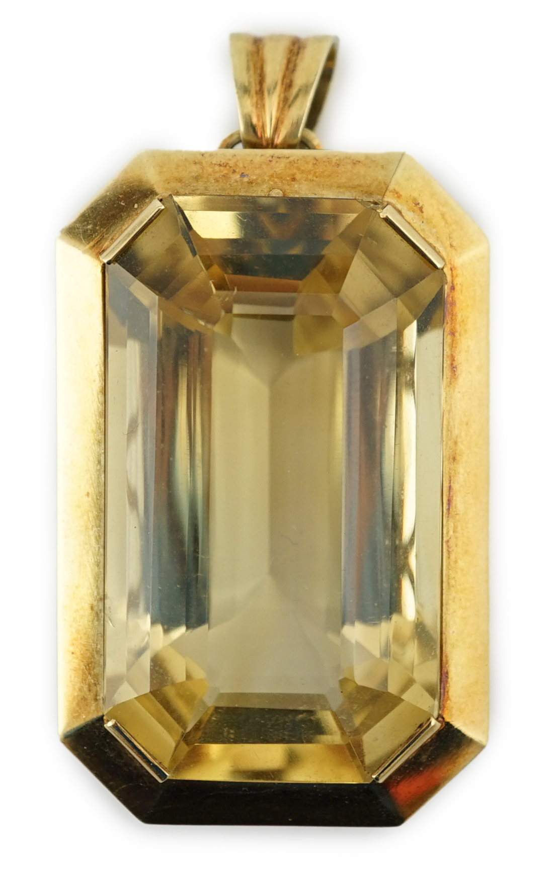 A large mid 20th century 14k gold and emerald cut citrine set pendant